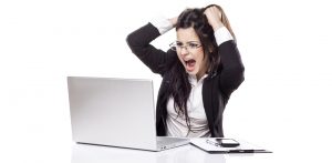 Woman at a computer pulling her hair out