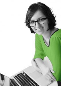 A smiling female Simpleworks professional at a laptop